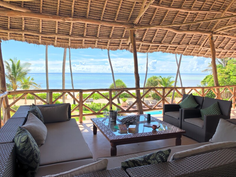 The upstairs lounge at Villa Turquoise under its makuti roof, open to the ocean